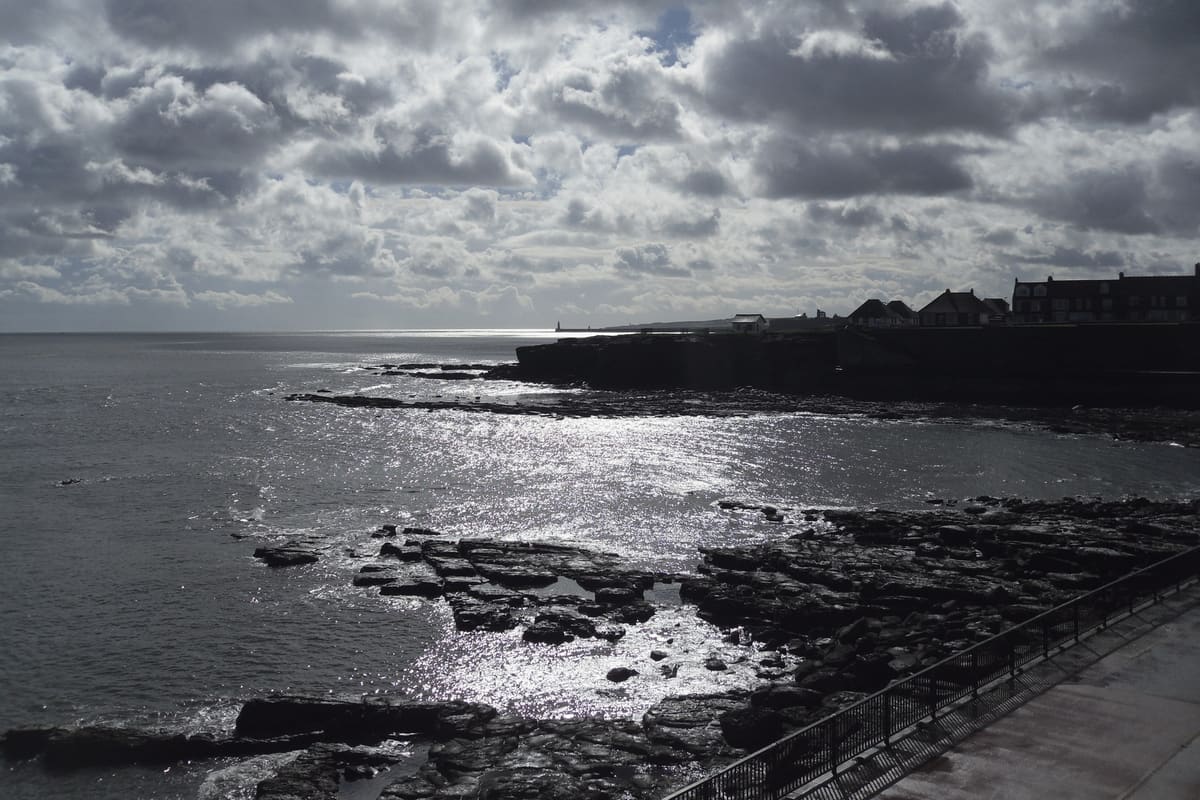 Low sun on the sea and rocks at Table Rocks, looking south-east along the coast towards Tynemouth